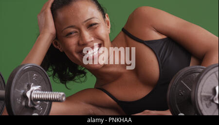 Felice razza mista donna ridere per fotocamera dopo l'allenamento su schermo verde Foto Stock