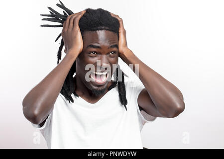 Ritratto di sorpreso uomo nero tenendo la testa nelle mani, urlando in preda al panico Foto Stock