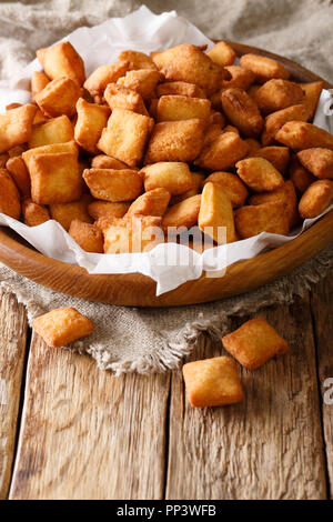 Natale nigeriano cibo: antipasto Chin Chin impasto fritto close-up in una ciotola sul piano verticale. Foto Stock