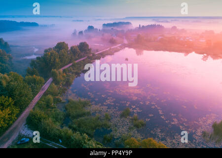 Magico tramonto sul lago. Foschia mattutina, paesaggio rurale. Vista aerea Foto Stock