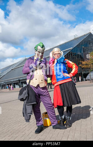 Glasgow, Scotland, Regno Unito. 23 Settembre, 2018. Cosplayers vestito come il fittizio supervillain Joker e Harley Quinn dal fumetto libri pubblicati da DC Comics, arrivando al giorno due di MCM Scozia Comic Con tenutasi presso la SEC Center. Credito: Berretto Alamy/Live News Foto Stock