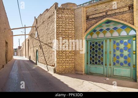 Strada tipica della vecchia città di Yazd, Iran, con le sue tipiche pareti in argilla, antiche porte e edifici di argilla. Yazd è la città principale del centro di Iran, un Foto Stock