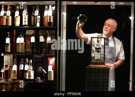 Danny McIlwraith di Bonhams pulisce il gabinetto che ospita il whisky più puro e prezioso del mondo - una bottiglia del Macallan Valerio Adami 60 anni 1926 con una stima di £700,000-900,000. Prima del Bonhams imminente Whisky sale presso la loro casa d'asta di Edimburgo, che è destinato a presentare il mondo più raest e whisky più prezioso - una bottiglia del Macallan Valerio Adami 60 anni 1926 con una stima di £ 700,000-900,000. Foto Stock