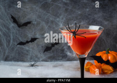 Bloody Mary cocktail, zucca con pipistrelli e ragni per la festa di Halloween, il fuoco selettivo. Foto Stock