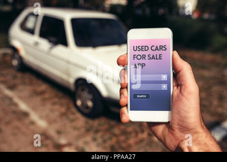 Auto Usate smartphone app mock up, concessionario tenendo il telefono cellulare Foto Stock