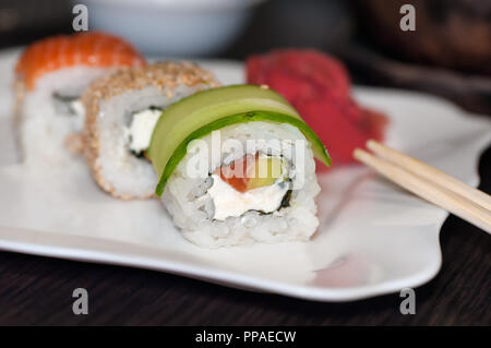 Rotoli di Sushi con pesce rosso, cetriolo e formaggio Filadelfia. Foto Stock