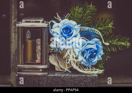 Fiori blu decorazione durante il giorno di Tutti i Santi al cimitero Foto Stock