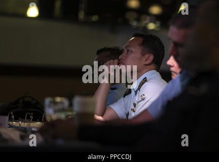 Ufficiali di Allied e nazioni partner ascoltare un briefing durante il 2018 Fighter la sicurezza e la logistica Simposio il Agosto 21, 2018 a Kadena Air Base, Giappone. Air Force officers di Australia, Indonesia, Giappone, Filippine, Singapore e la Tailandia hanno partecipato al Simposio per incrementare fighter interoperabilità entro la regione del Pacifico. Foto Stock