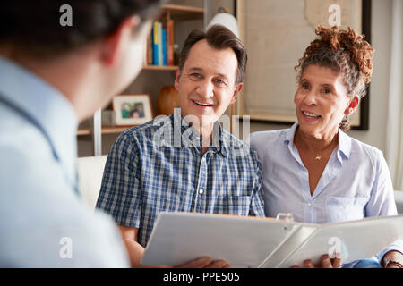 Coppia senior incontro con maschio di advisor finanziario a casa Foto Stock