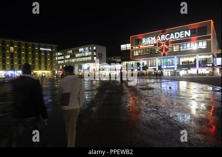 Willy-Brandt-Platz con il Riem Arkaden centro shopping di notte. Foto Stock