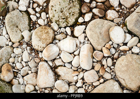 Riverbed ciottoli, tono caldo immagine di sfondo. Foto Stock