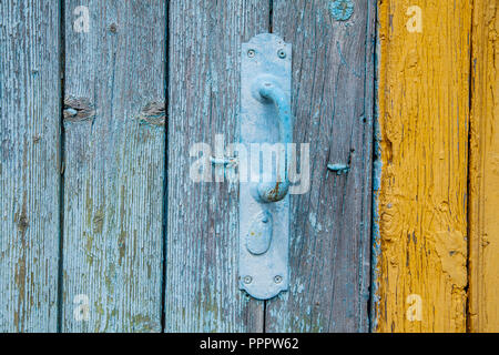 Vecchio Blu maniglia della porta fatta di metallo su una porta di legno Foto Stock