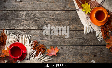 Autunno sfondo con tazza di tè, plaid e foglie Foto Stock