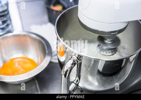 Albumi montati a neve in cucina professionale mixer in un ristorante Foto Stock