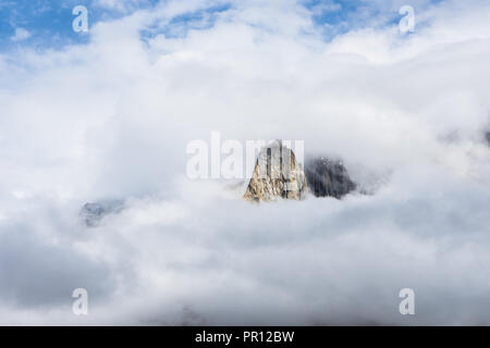 Cime frastagliate da Biarchedi gruppo di montagne appaiono dietro le nuvole, Baltoro Galcier, Karakoram, Pakistan Foto Stock