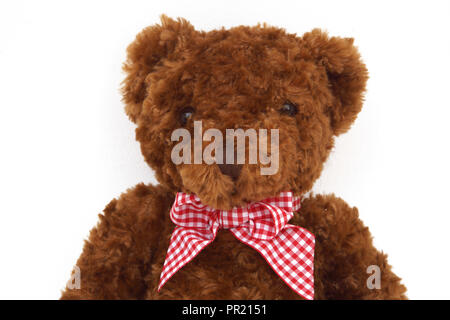 Brown Orsacchiotto di peluche con il rosso e nastro bianco Foto Stock