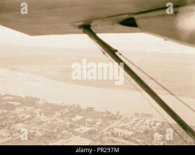 L'Egitto. Tebe al confine meridionale dell'Egitto. Vista aerea. Edfu, che mostra la città più recenti, Nilo, e per i campi al di là. 1936, Egitto, Idfū Foto Stock