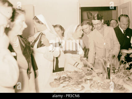 Danza in Dr. & Mrs. Wren's House infermieri e altri ospiti intorno a un tavolo buffet, Israele Foto Stock