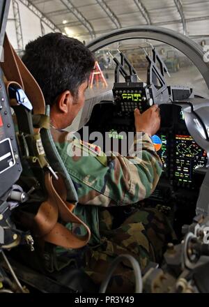 Un Afghan Air Force A-29 Super Tucano maintainer esegue un controllo di avionica nella cabina di pilotaggio del velivolo a Kabul Air Wing, Afghanistan, luglio 26, 2017. Recentemente, AAF A-29 leadership di manutenzione richiesto di assumersi la piena responsabilità per la linea di volo operazioni di manutenzione dal treno, consulenza, assistenza Command-Air consulenti e contratti di manutenzione. Questa iniziativa con il manutentore è un altro passo avanti per la serie AAF diventando un professionista, capace e forza sostenibile. Foto Stock