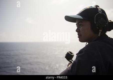 Oceano Pacifico (Luglio 23, 2017) marinaio Jaizza Escalante, nativo di Anaheim, California, assegnato alla sezione di coperta a bordo del dock anfibio sbarco nave USS Pearl Harbor (LSD 52), sorge guarda sulla nave del ponte meteo. Pearl Harbor è attualmente impegnato su una distribuzione programmata come parte dell'America anfibio gruppo pronto, che è composto di più di 1.800 marinai e 2.600 marines assegnato all'assalto anfibio nave USS America (LHA 6), il trasporto anfibio dock nave USS San Diego (LPD 22), e il porto di perla. Foto Stock