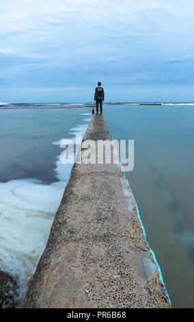 In attesa che la tempesta di Narrabeen ocean pool Foto Stock