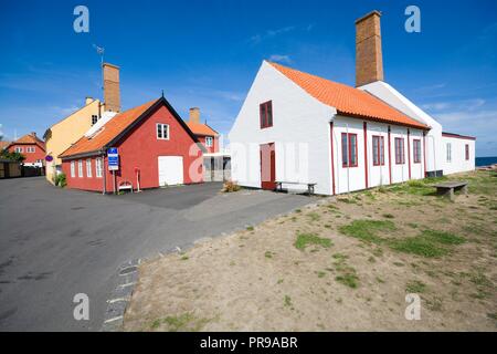 Piccola colorata semi-case con travi di legno con camini smokery in Gudhjem, Bornholm, Danimarca. Foto Stock