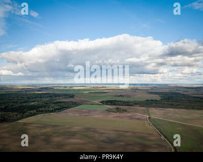 Vista aerea dell'agricoltura campi durante la soleggiata giornata autunnale. Cielo di nuvole pesanti. Foto Stock