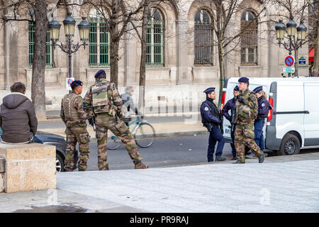 Parigi, Francia - 13 Marzo 2018: Esercito Francese soldati con gli ufficiali di polizia pattuglia a Parigi in connessione con la minaccia del terrorismo Foto Stock