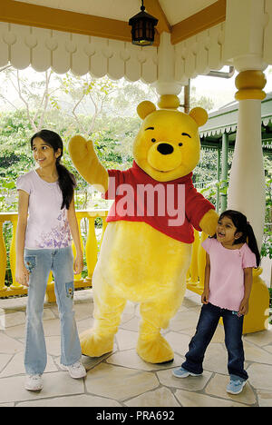 Due sorelle in posa per un ritratto con WINNIE THE POOH A HONG KONG DISNEYLAND Foto Stock