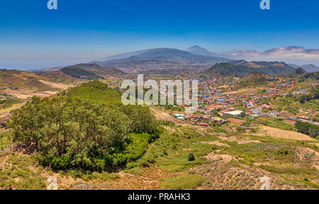 TENERIFE, Spagna - 20 agosto: (nota del redattore: Immagine è una digitale [High Dynamic Range HDR] composito.) dietro la città di La Laguna è il picco del vulcano Teide è visto dal Mirador De Jardina lookout su agosto 20, 2018 a Tenerife, Spagna. Da primavera ad autunno è il picco del Teide in gran parte visibile sopra le nuvole. Foto Stock