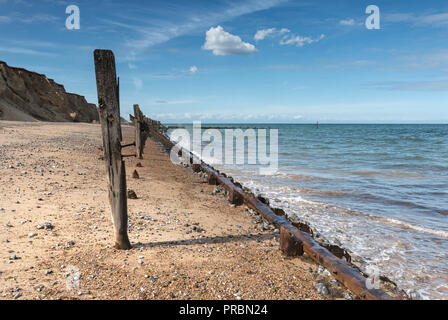 Pennelli in legno e revetments, fatiscente sulla West Runton Beach, North Norfolk. Foto Stock