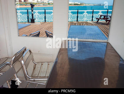 Posti a sedere al riparo Palace Pier ,Brighton sussex Gran Bretagna, liesure pier boardwalk Foto Stock