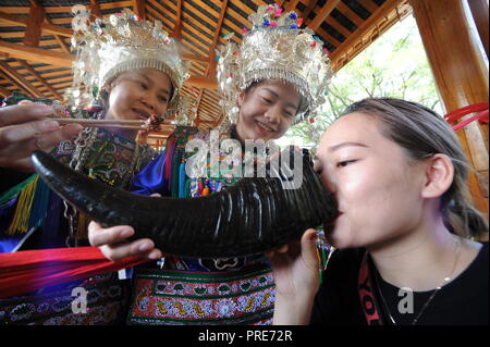 Rongjiang, della Cina di Guizhou. 2 Ottobre, 2018. Le donne di Dong gruppo etnico benvenuti un turista con vino al villaggio Wugong in Rongjiang County, a sud-ovest della Cina di Guizhou, Ottobre 2, 2018. La contea ha ricevuto più di 70.000 turisti nei primi due giorni della settimana lunga giornata nazionale di vacanza. Credito: Yang Ying/Xinhua/Alamy Live News Foto Stock