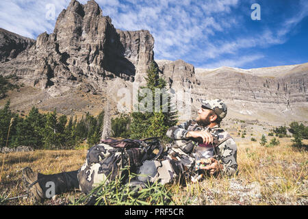 16 settembre 2018 - DUBOIS, Wyoming: Elk hunter prendendo una pausa mangiando il sentiero si mescolano in un sacchetto con vista del fiume del vento gamma delle Montagne Rocciose in Foto Stock