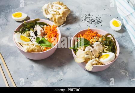 Miso Ramen noodle asiatici in ciotole su sfondo di calcestruzzo. Foto Stock