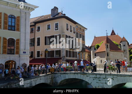 I turisti su un ponte con negozi e caffetterie Annecy Francia Foto Stock