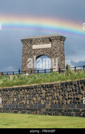 Rainbow oltre il Roosevelt arco all'entrata nord del Parco Nazionale di Yellowstone. Foto Stock