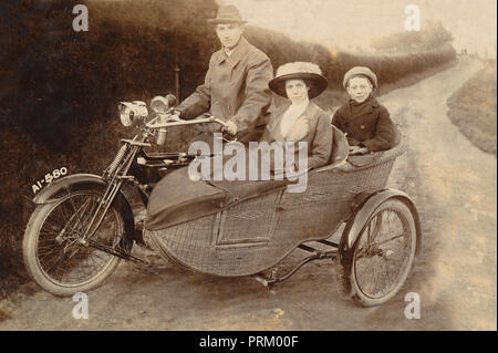 Gentleman rider e sua moglie & figlio posano per una fotografia su un 1906 Royal Enfield moto & sidecar di vimini in un vicolo del paese circa 1906 Foto Stock