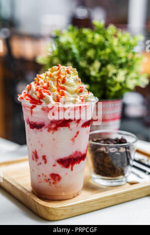 Frappé di fragole con panna montata su tavolo Foto Stock