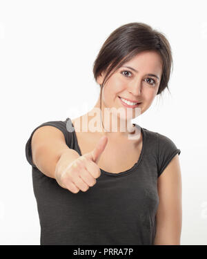 Giovane donna pollice in alto Foto Stock