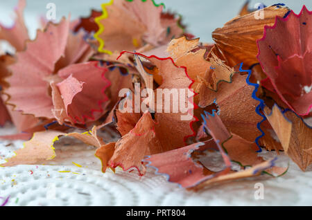 Trucioli di affilatura matite colorate sul tavolo bianco, close up Foto Stock