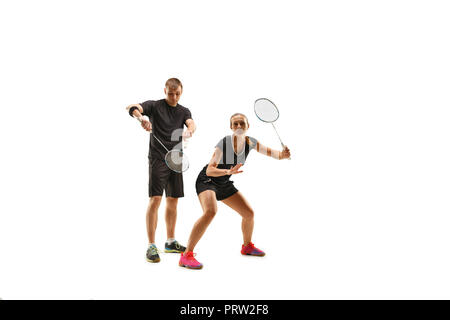 Giovane giocando con le racchette da badminton isolato su bianco studio Foto Stock