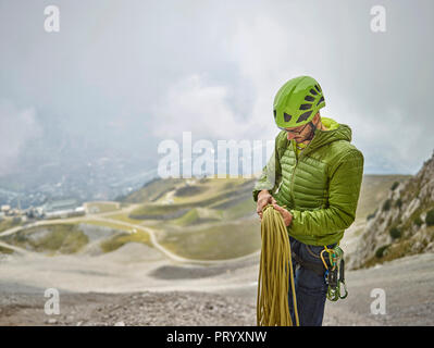 Austria, Innsbruck, Nordkette, uomo con corda e arrampicata attrezzature Foto Stock