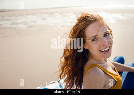 Ritratto di una donna redheaded, ridevano allegramente sulla spiaggia Foto Stock