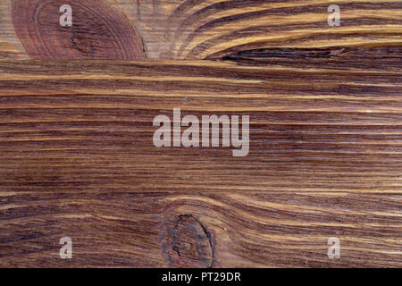 Legno pregiato texture. Di aspetto rustico e scuro, ocra, marrone, tostato, toni di nero. Le venature e i nodi sono apprezzati. Foto Stock