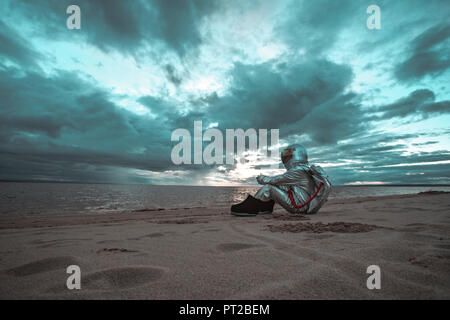 Lonely spaceman guardando il lago sul pianeta anonimi Foto Stock