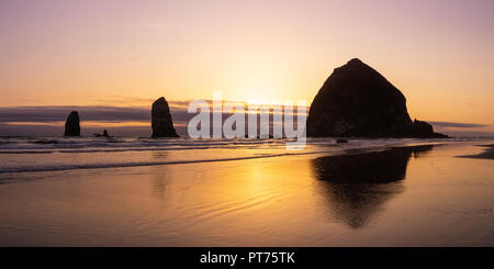 Il tramonto del Haystack Rock, Oregon Islands National Wildlife Refuge, Cannon Beach, Pacifc Costa, STATI UNITI D'AMERICA. Foto Stock