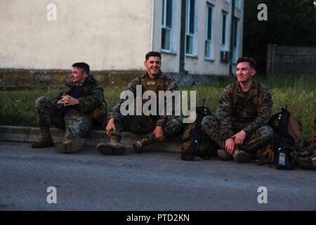 Stati Uniti Marines con il Mar Nero La forza di rotazione 17.1 prendere una pausa durante una società di sei miglia escursione a bordo di Mihail Kogalniceanu Air Base, Romania, Luglio 7, 2017. Lo scopo di questa escursione è stato quello di costruire i Marines endurance e prepararli per eventuali sfide si possono affrontare. Foto Stock