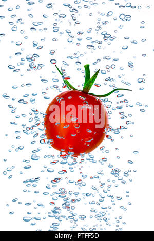 Little cherry pomodoro schizzi in acqua con bolle di aria Foto Stock