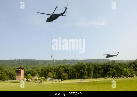 Soldati con Fort Indiantown Gap inaugurale della Air Assault Course rappel da un UH-60 Black Hawk elicottero azionato da pilota dall'esercito orientale la guardia nazionale di aviazione Sito di formazione Luglio 20, 2017. I dieci giorni di corso progettato per preparare i soldati per inserimento, evacuazione e pathfinder missioni che richiedono l'uso di mezzi di trasporto multiuso e elicotteri d'assalto. Fort Indiantown Gap è solo uno dei sette siti di formazione di offrire Air Assault scuola. Foto Stock